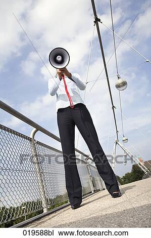 young businesswoman standing on bridge hidden behind megaphone View Large Photo Image Stock Image - young businesswoman standing on bridge hidden behind megaphone. Fotosearch