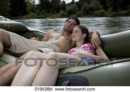 young couple relaxing on rubber boat by river View Large Photo Image Stock Image - young couple relaxing on rubber boat by river. Fotosearch