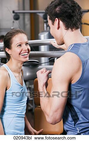young couple talking to each other in gym View Large Photo Image Stock Image - young couple talking to each other in gym. Fotosearch