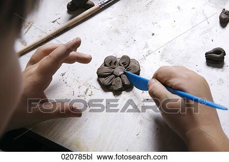 young girl forming flower out of clay View Large Photo Image Stock Image - young girl forming flower out of clay. Fotosearch