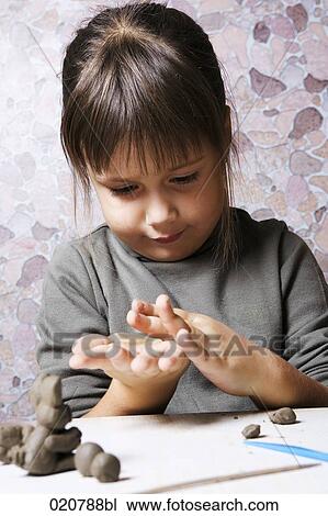 young girl working with clay View Large Photo Image Stock Image - young girl working with clay. Fotosearch