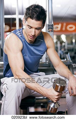 young man exercising with dumb bell View Large Photo Image Stock Image - young man exercising with dumb bell. Fotosearch