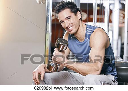 young man exercising with dumb bell View Large Photo Image Stock Image - young man exercising with dumb bell. Fotosearch