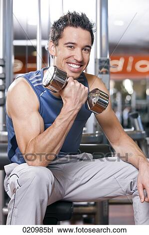 young man exercising with dumb bell View Large Photo Image Stock Image - young man exercising with dumb bell. Fotosearch