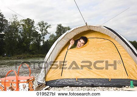 young man peeking through tent in the morning View Large Photo Image Stock Image - young man peeking through tent in the morning. Fotosearch