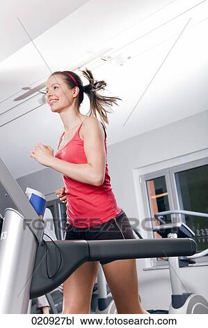 young woman exercising on treadmill in gym View Large Photo Image Stock Image - young woman exercising on treadmill in gym. Fotosearch