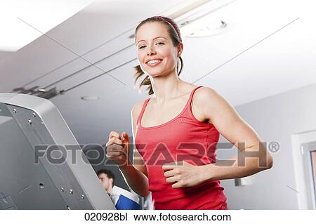 young woman exercising on treadmill in gym View Large Photo Image Stock Image - young woman exercising on treadmill in gym. Fotosearch