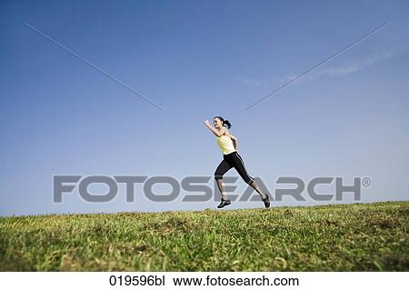 young woman jogging in park View Large Photo Image Stock Image - young woman jogging in park. Fotosearch