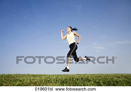 young woman jogging in park View Large Photo Image Stock Image - young woman jogging in park. Fotosearch