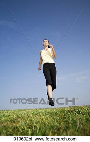 young woman jogging in park View Large Photo Image Stock Image - young woman jogging in park. Fotosearch