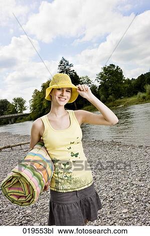young woman with yellow hat walking along river in summer View Large Photo Image Stock Image - young woman with yellow hat walking along river in summer. Fotosearch