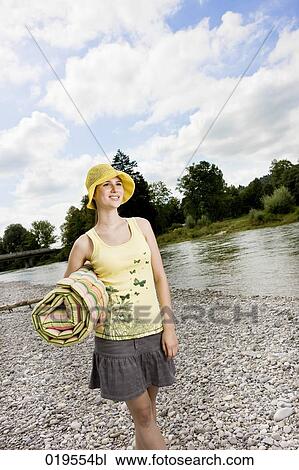 young woman with yellow hat walking along river in summer View Large Photo Image Stock Image - young woman with yellow hat walking along river in summer. Fotosearch