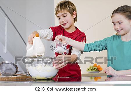 brother and sister mixing dough in bowl together View Large Photo Image Stock Image - brother and sister mixing dough in bowl together. Fotosearch