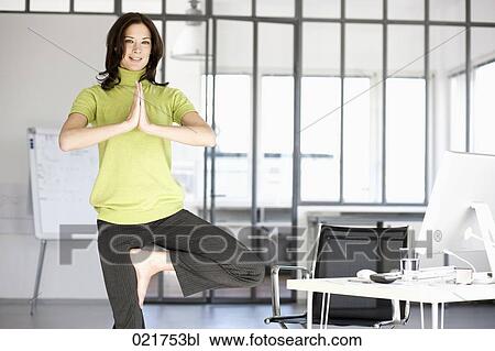 businesswoman doing yoga in office View Large Photo Image Stock Image - businesswoman doing yoga in office. Fotosearch