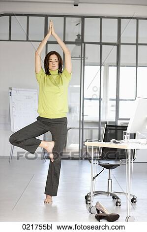 businesswoman doing yoga in office View Large Photo Image Stock Image - businesswoman doing yoga in office. Fotosearch