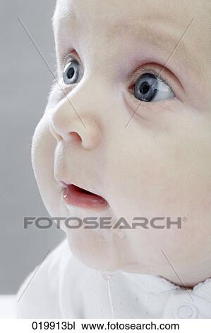 Stock Image - close-up of astonished looking baby. Fotosearch