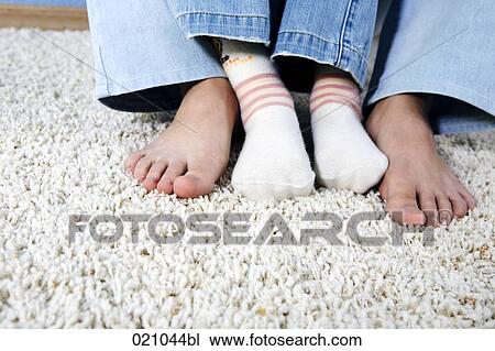 close-up of feet of mother and child sitting together on carpet View Large Photo Image Stock Image - close-up of feet of mother and child sitting together on carpet. Fotosearch
