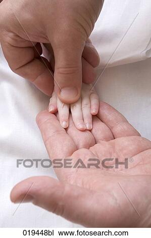close-up of man holding tiny hand of baby View Large Photo Image Stock Image - close-up of man holding tiny hand of baby. Fotosearch