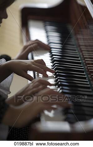close-up of mother and daughter playing four handed piano View Large Photo Image Stock Image - close-up of mother and daughter playing four handed piano. Fotosearch