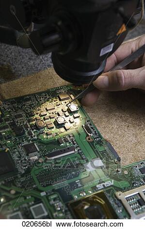 close-up of worker repairing motherboard of computer View Large Photo Image Stock Image - close-up of worker repairing motherboard of computer. Fotosearch