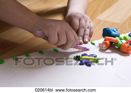 close-up of young girl playing with modelling clay View Large Photo Image Stock Image - close-up of young girl playing with modelling clay. Fotosearch