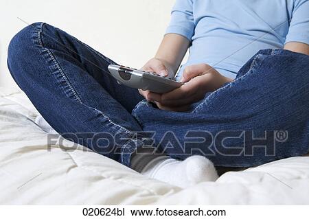 close-up of young girl sitting on sofa watching television View Large Photo Image Stock Image - close-up of young girl sitting on sofa watching television. Fotosearch
