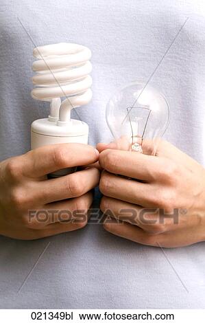 close-up of young woman holding conventional and low energy light bulb View Large Photo Image Stock Image - close-up of young woman holding conventional and low energy light bulb. Fotosearch