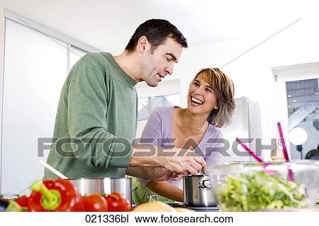 couple cooking in kitchen together View Large Photo Image Stock Image - couple cooking in kitchen together. Fotosearch