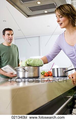 couple cooking together in kitchen View Large Photo Image Stock Image - couple cooking together in kitchen. Fotosearch