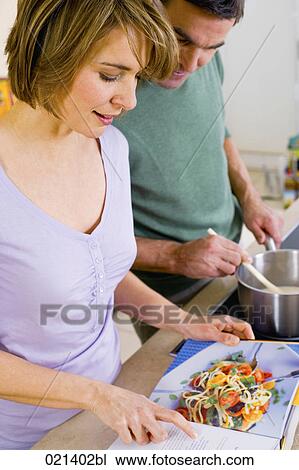 couple reading cookbook View Large Photo Image Stock Image - couple reading cookbook. Fotosearch