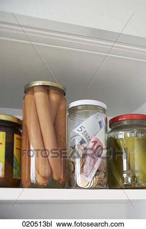 cupboard in kitchen with jar containing money View Large Photo Image Stock Image - cupboard in kitchen with jar containing money. Fotosearch