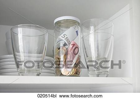 cupboard in kitchen with jar containing money View Large Photo Image Stock Image - cupboard in kitchen with jar containing money. Fotosearch