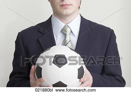 detail of young businessman holding football View Large Photo Image Stock Image - detail of young businessman holding football. Fotosearch