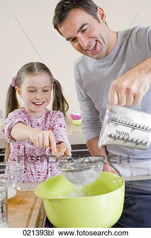 father and young daughter cooking together View Large Photo Image Stock Image - father and young daughter cooking together. Fotosearch