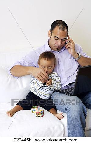 father on sofa talking on mobile phone and playing with little son View Large Photo Image Stock Image - father on sofa talking on mobile phone and playing with little son. Fotosearch