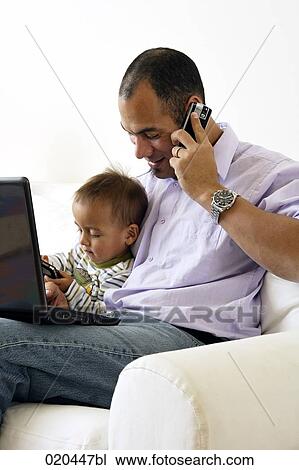 father on sofa talking on mobile phone and playing with little son View Large Photo Image Stock Image - father on sofa talking on mobile phone and playing with little son. Fotosearch