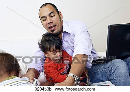 father on sofa with laptop computer and his two sons View Large Photo Image Stock Image - father on sofa with laptop computer and his two sons. Fotosearch