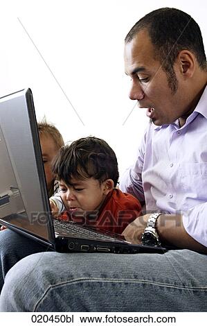 father showing his two sons laptop computer View Large Photo Image Stock Image - father showing his two sons laptop computer. Fotosearch