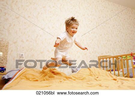 full body portrait of young boy jumping on bed View Large Photo Image Stock Image - full body portrait of young boy jumping on bed. Fotosearch