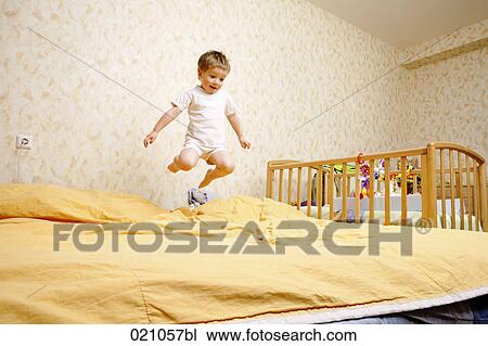 full body portrait of young boy jumping on bed View Large Photo Image Stock Image - full body portrait of young boy jumping on bed. Fotosearch