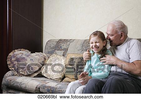 grandfather playing with young girl on sofa View Large Photo Image Stock Image - grandfather playing with young girl on sofa. Fotosearch
