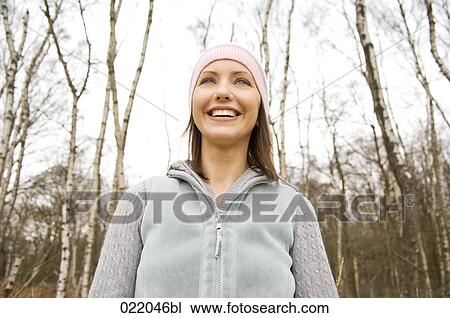 low angle portrait of young woman in autumn View Large Photo Image Stock Image - low angle portrait of young woman in autumn. Fotosearch