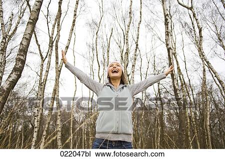 low angle portrait of young woman in autumn View Large Photo Image Stock Image - low angle portrait of young woman in autumn. Fotosearch