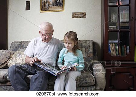 mature man reading book with granddaughter View Large Photo Image Stock Image - mature man reading book with granddaughter. Fotosearch