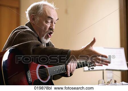 mature music instructor making gesture during lesson View Large Photo Image Stock Image - mature music instructor making gesture during lesson. Fotosearch