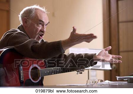 mature music instructor making gesture during lesson View Large Photo Image Stock Image - mature music instructor making gesture during lesson. Fotosearch
