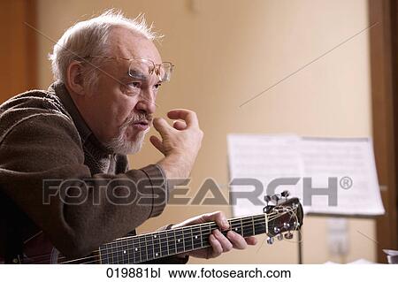 Stock Image - mature music instructor making gesture during lesson. Fotosearch
