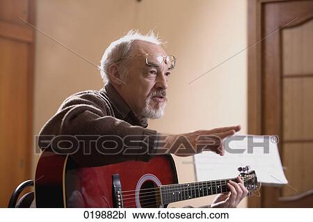 Stock Image - mature music instructor making gesture during lesson. Fotosearch