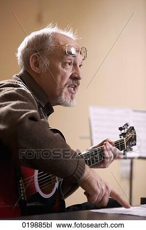 mature music instructor making gesture during lesson View Large Photo Image Stock Image - mature music instructor making gesture during lesson. Fotosearch