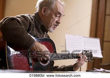 mature music instructor playing guitar View Large Photo Image Stock Image - mature music instructor playing guitar. Fotosearch
